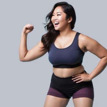 Asian woman in workout clothes flexing her arm