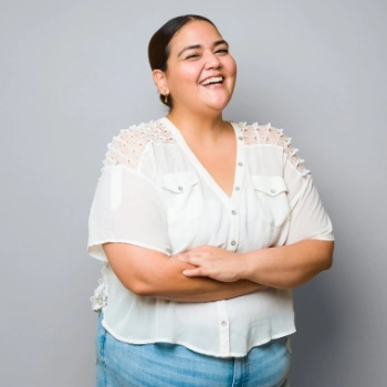 Happy woman in white shirt laughing